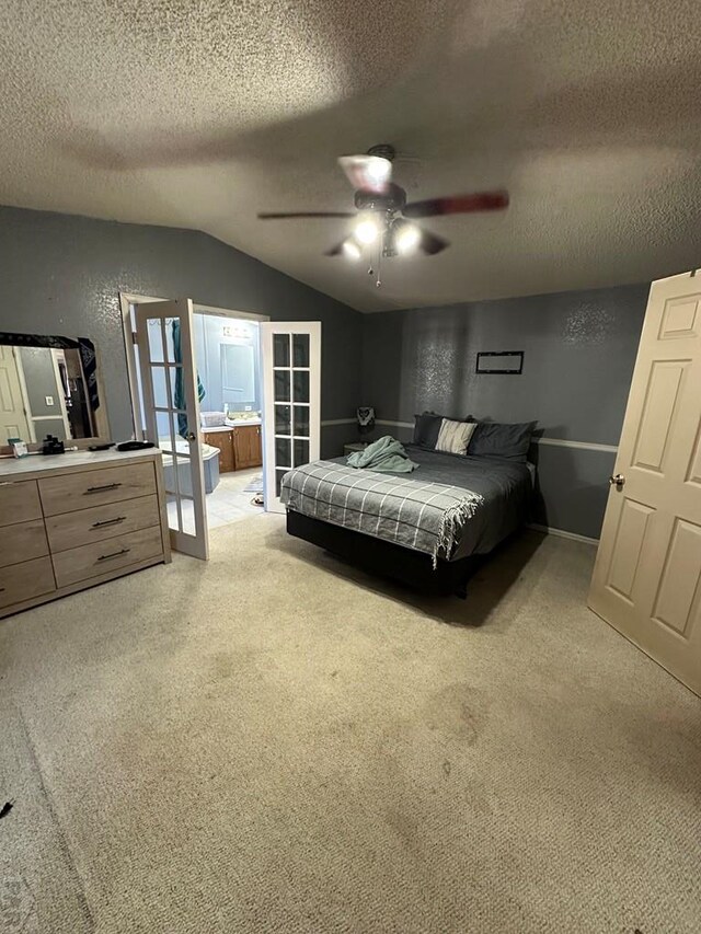 bedroom featuring a textured ceiling, a textured wall, light carpet, vaulted ceiling, and french doors