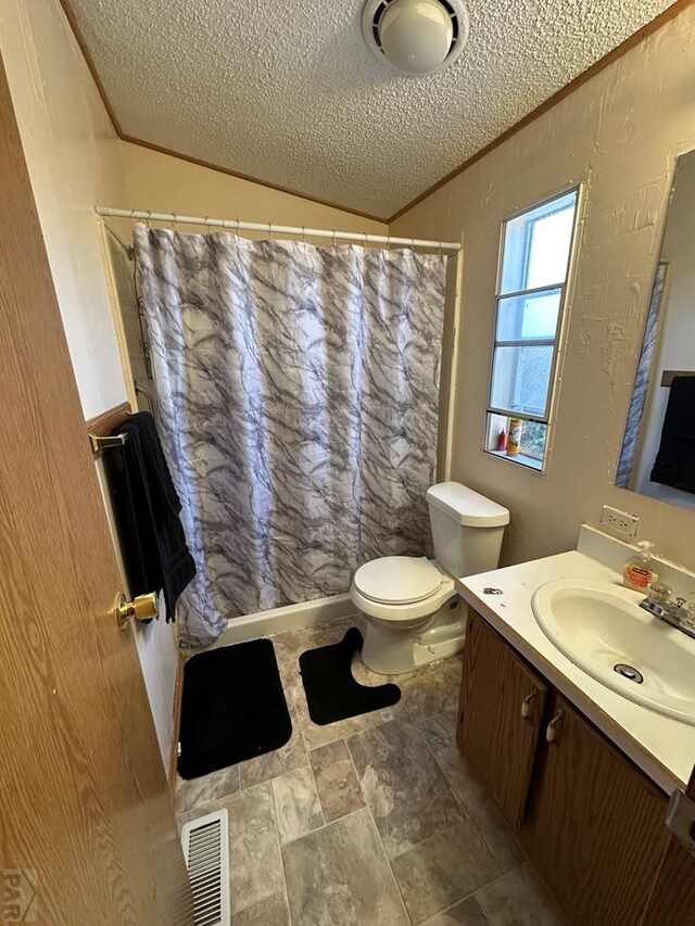 bathroom featuring visible vents, toilet, vaulted ceiling, crown molding, and vanity