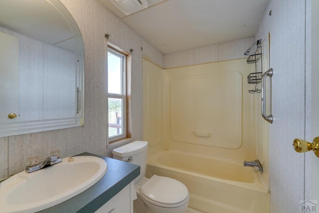 bathroom featuring toilet, wallpapered walls, bathing tub / shower combination, and vanity