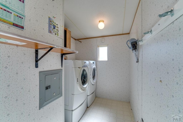 laundry area featuring laundry area, light floors, washing machine and clothes dryer, and electric panel