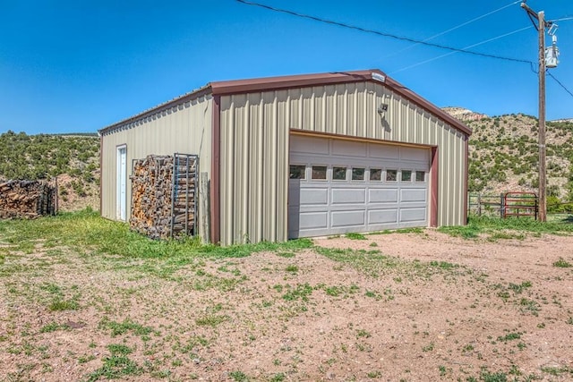 detached garage featuring fence