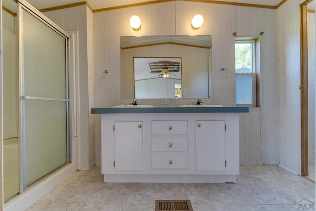 full bath with double vanity, visible vents, a stall shower, a sink, and wallpapered walls