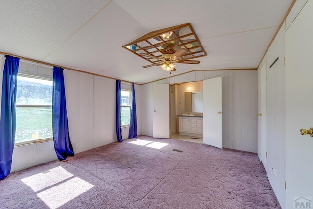 unfurnished bedroom with lofted ceiling, light carpet, visible vents, and a ceiling fan