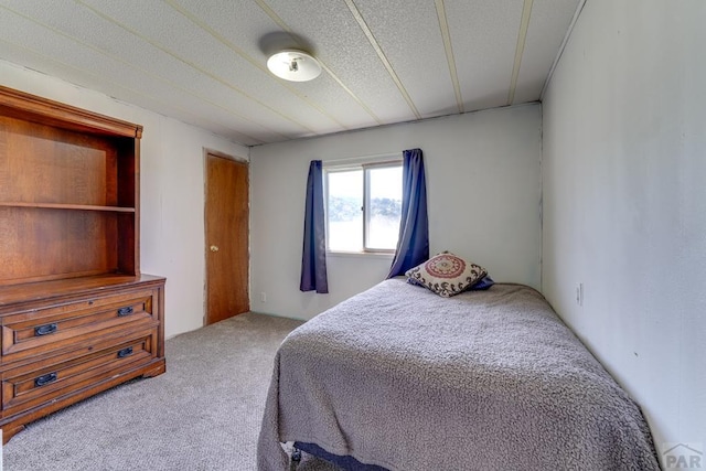 carpeted bedroom with a textured ceiling