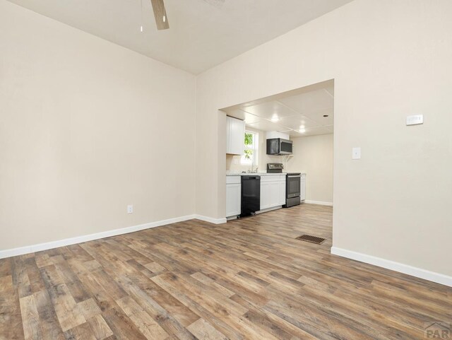 1415 E 2nd St, Pueblo, CO 81001 - kitchen featuring appliances with stainless steel finishes, wood finished floors, ceiling fan, baseboards, and open floor plan