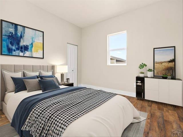 1415 E 2nd St, Pueblo, CO 81001 - bedroom with dark wood-type flooring and baseboards
