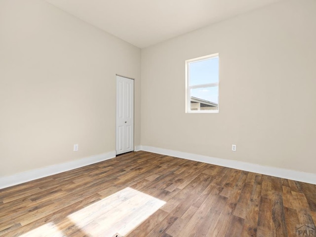 1415 E 2nd St, Pueblo, CO 81001 - spare room featuring baseboards and wood finished floors