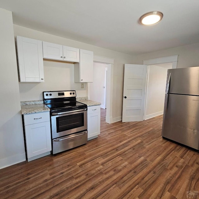 1938 E 6th St, Pueblo, CO 81001 - kitchen featuring stainless steel appliances, dark wood-style flooring, white cabinets, and light stone countertops