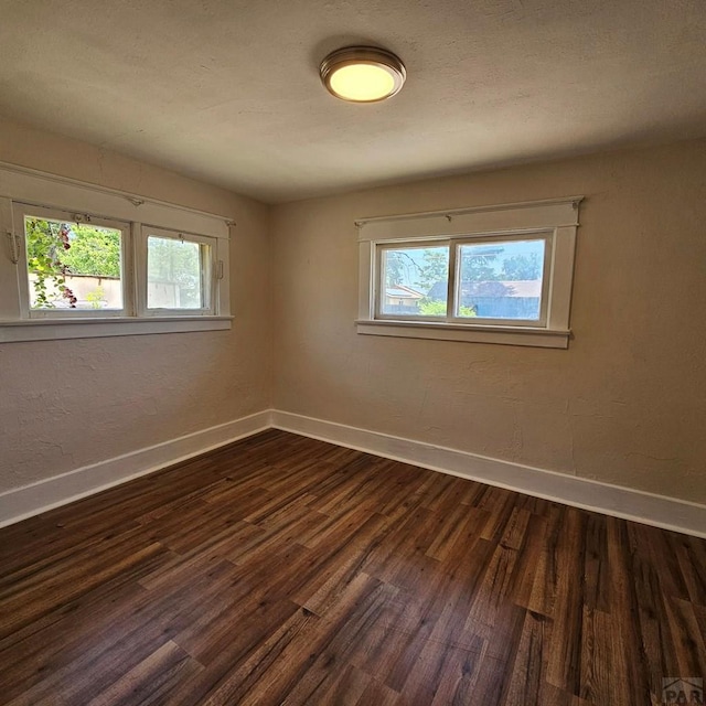 1938 E 6th St, Pueblo, CO 81001 - unfurnished room featuring plenty of natural light and dark wood-type flooring