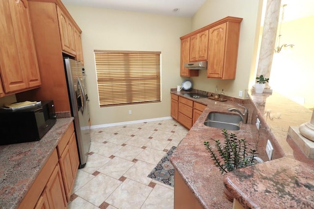 746 E Paseo Dorado Dr, Pueblo West, CO 81007 - kitchen with freestanding refrigerator, under cabinet range hood, black microwave, electric stovetop, and stone counters