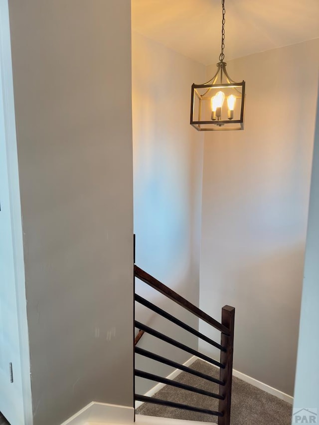 476 S Hahns Peak Ave, Pueblo West, CO 81007 - stairs featuring a chandelier and carpet floors
