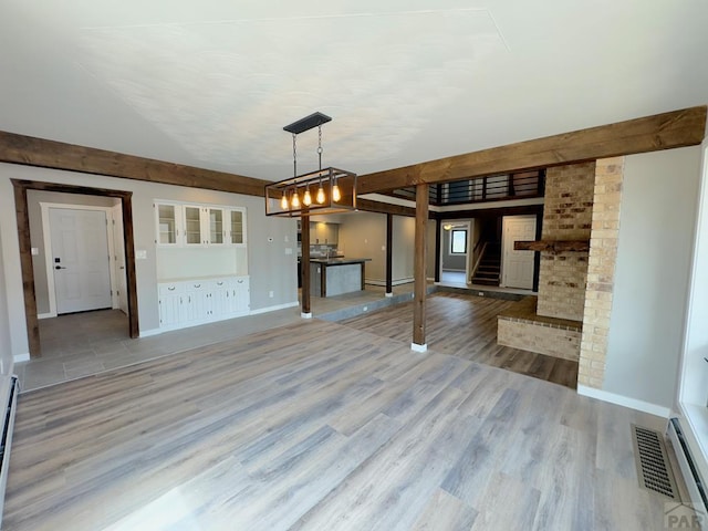 476 S Hahns Peak Ave, Pueblo West, CO 81007 - unfurnished living room featuring stairway, light wood-style floors, and a chandelier