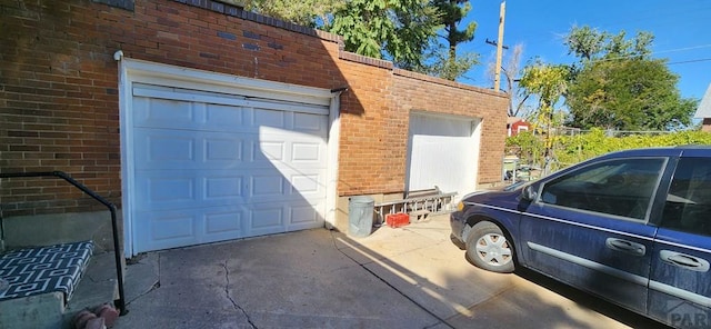 garage featuring concrete driveway