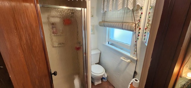 full bathroom with toilet and a shower with door