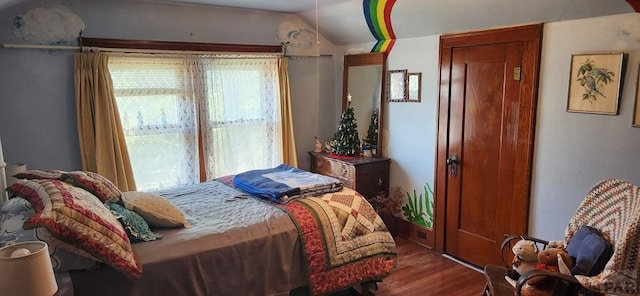 bedroom featuring vaulted ceiling and wood finished floors