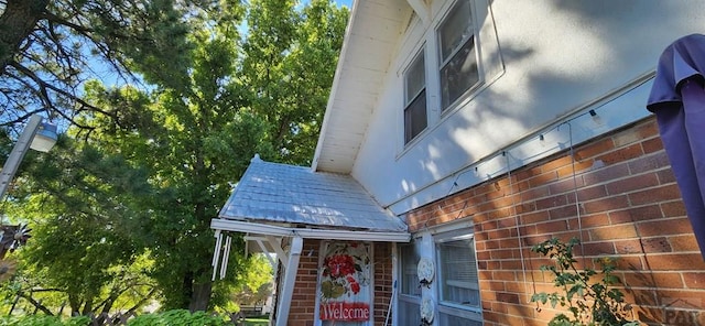 view of property exterior with brick siding