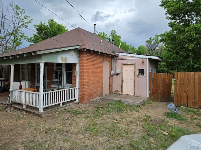 00913 6th St, Walsenburg, CO 81089 - rear view of house with brick siding and roof with shingles