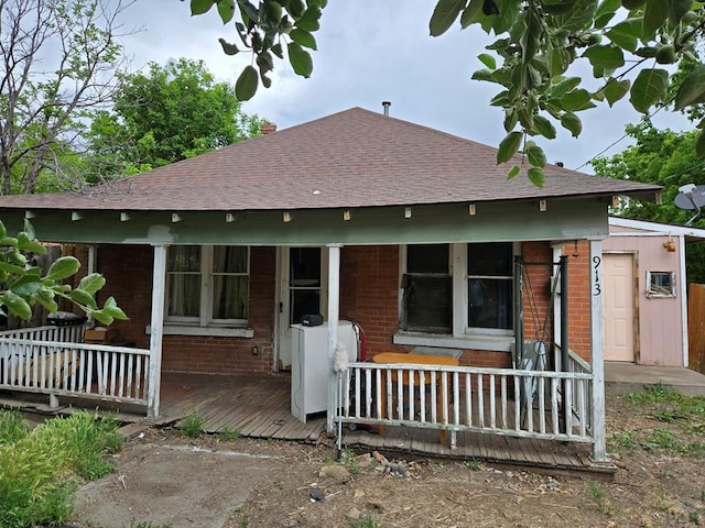 00913 6th St, Walsenburg, CO 81089 - back of house with brick siding, a shingled roof, and a porch