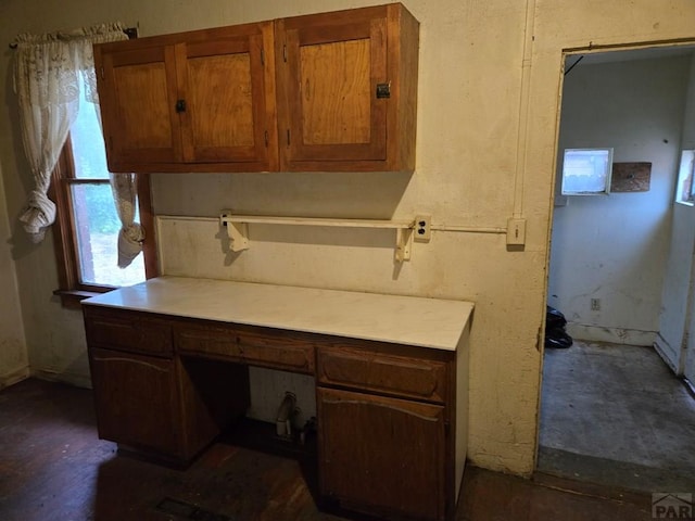 00913 6th St, Walsenburg, CO 81089 - kitchen featuring brown cabinets, built in study area, and light countertops