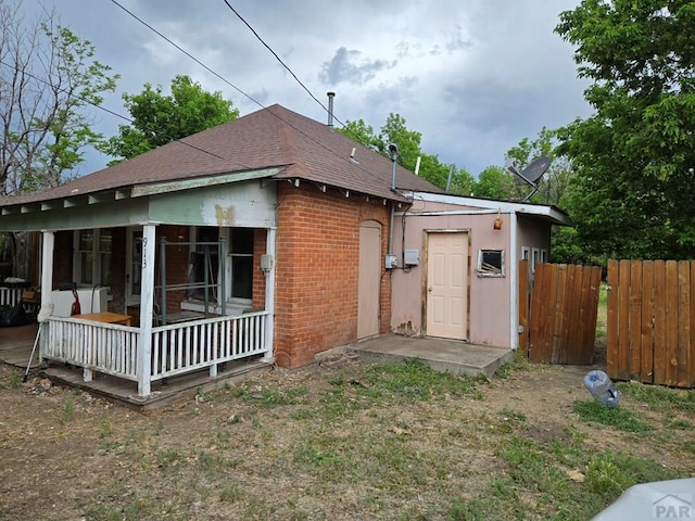 00913 6th St, Walsenburg, CO 81089 - rear view of property with brick siding and a shingled roof