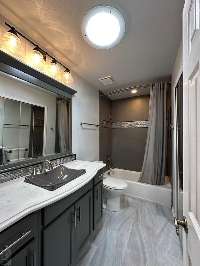 bathroom featuring visible vents, shower / bathtub combination with curtain, toilet, vanity, and a textured ceiling