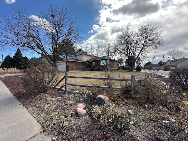 view of yard with a fenced front yard and an attached garage