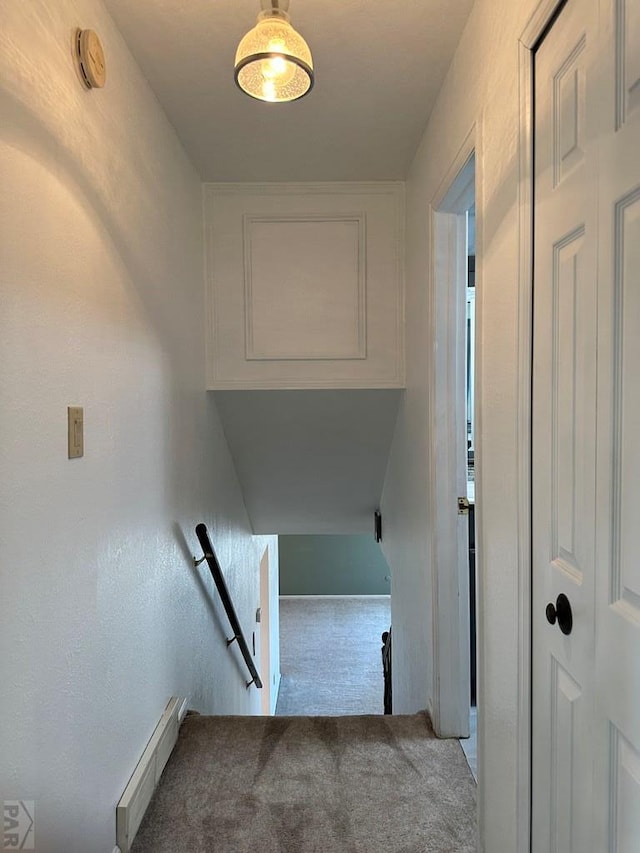 stairs with a baseboard radiator