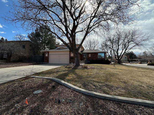 view of front of home featuring a garage, brick siding, fence, concrete driveway, and a front yard