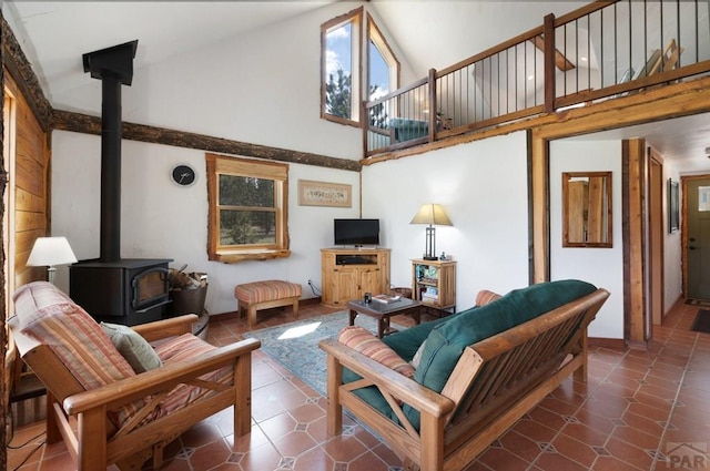 2793 Black Fawn Ln, Westcliffe, CO 81252 - tiled living room with a wood stove and high vaulted ceiling