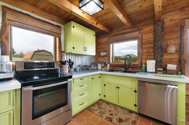 2793 Black Fawn Ln, Westcliffe, CO 81252 - kitchen featuring appliances with stainless steel finishes, green cabinetry, a wood ceiling with exposed beams, light countertops, and light tile patterned floors