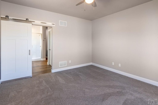 unfurnished bedroom with visible vents, baseboards, ceiling fan, and carpet floors