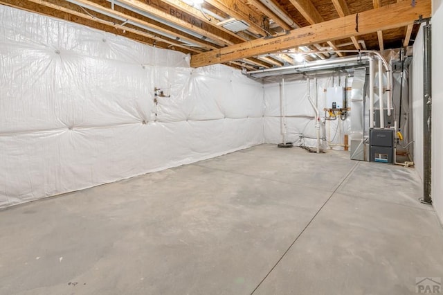 unfinished basement featuring heating unit