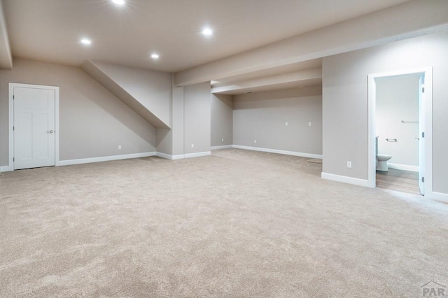 additional living space featuring baseboards, recessed lighting, and light colored carpet