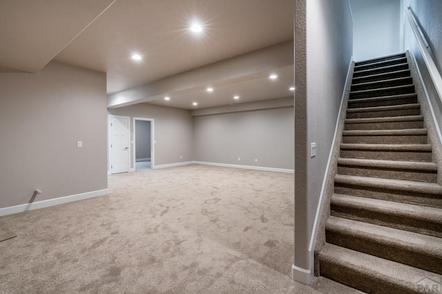 finished basement featuring carpet floors, baseboards, recessed lighting, and stairs