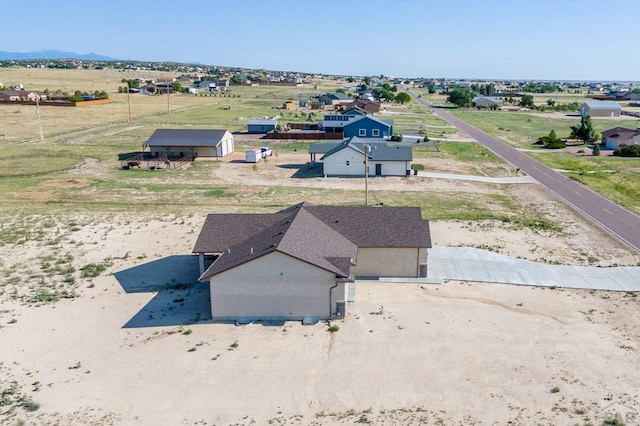 birds eye view of property with a rural view