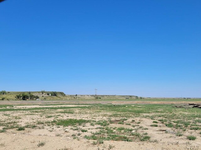 view of yard with a rural view