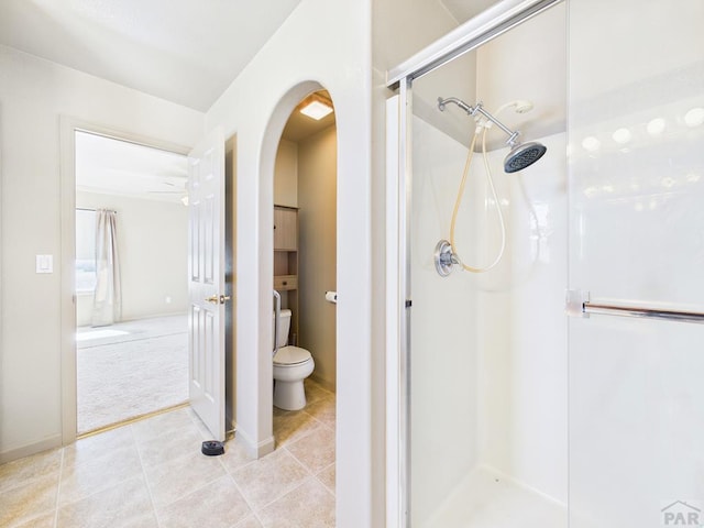 full bathroom with toilet, a shower stall, and tile patterned floors