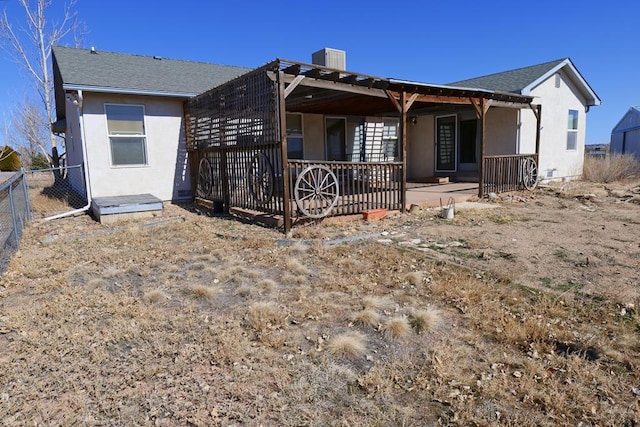 view of front of home with fence and stucco siding