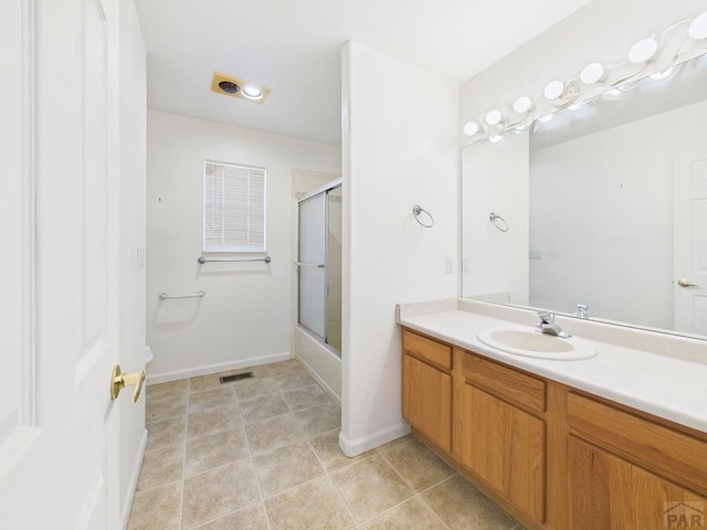 full bath featuring visible vents, bath / shower combo with glass door, tile patterned flooring, and vanity