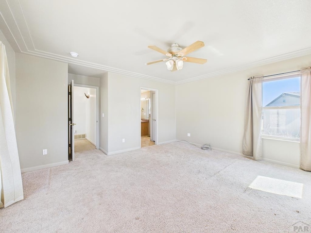 unfurnished bedroom featuring baseboards, connected bathroom, ceiling fan, ornamental molding, and carpet flooring