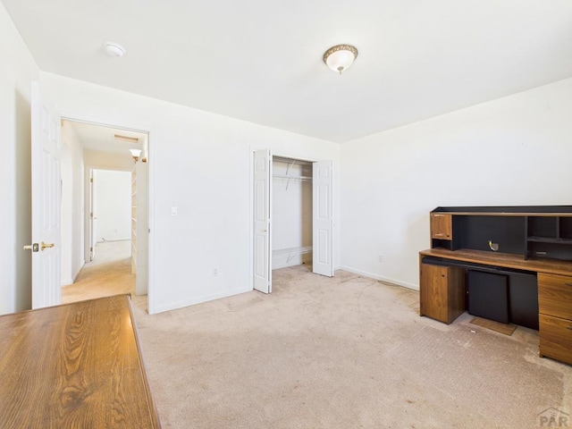 office space featuring baseboards and light colored carpet