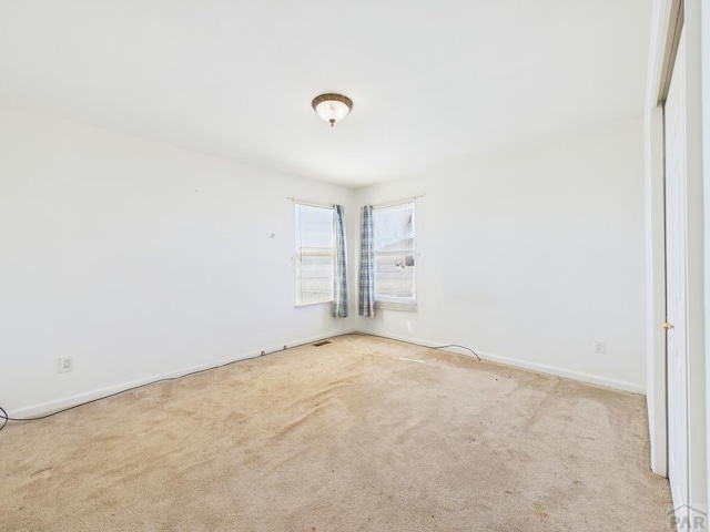 spare room with carpet flooring and baseboards