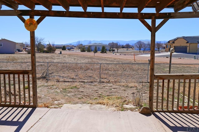 view of yard with fence and a mountain view