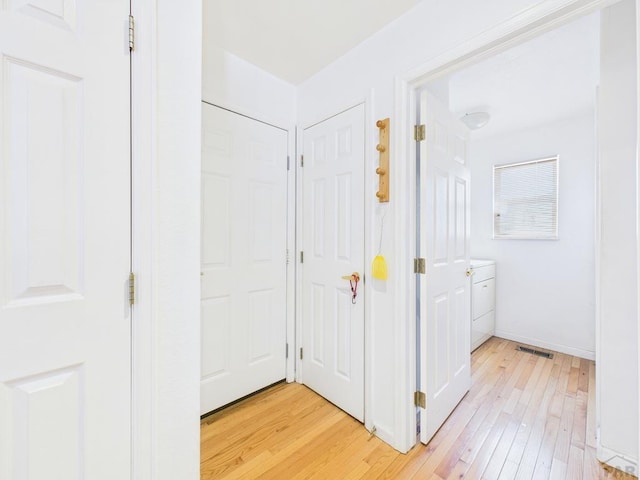 bathroom featuring wood-type flooring, visible vents, and baseboards