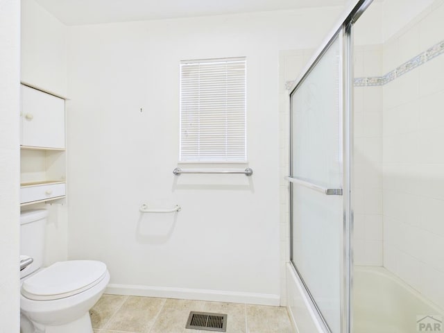 bathroom with visible vents, baseboards, toilet, enclosed tub / shower combo, and tile patterned flooring