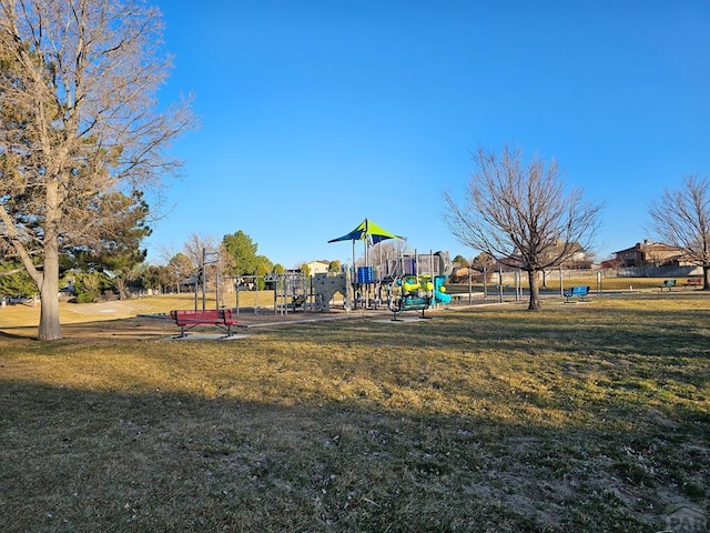 community jungle gym featuring a yard