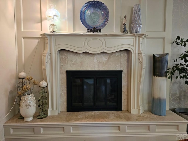 interior details featuring a tiled fireplace