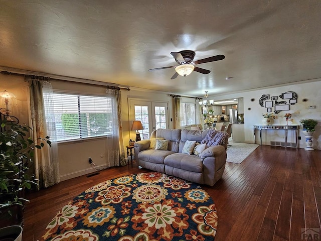 living area with visible vents, baseboards, a ceiling fan, and hardwood / wood-style flooring