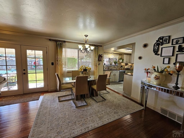 dining space with visible vents, hardwood / wood-style floors, crown molding, and french doors