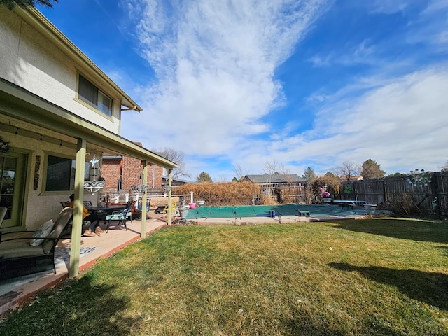 view of yard featuring a fenced in pool, a patio, and fence